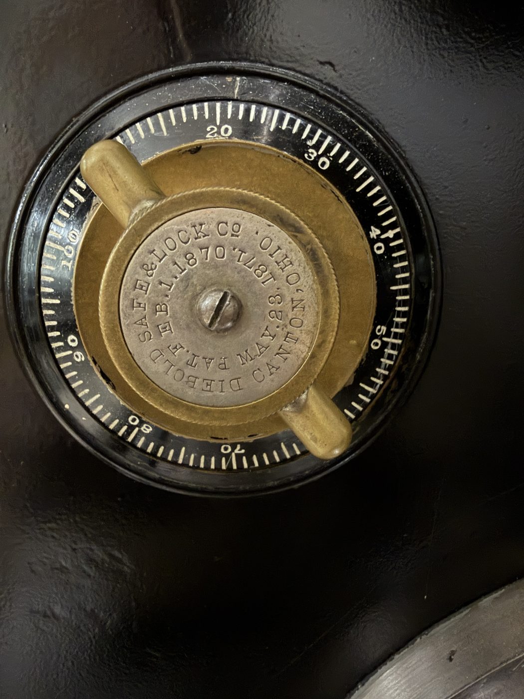 The original brass combination dial on the vault door